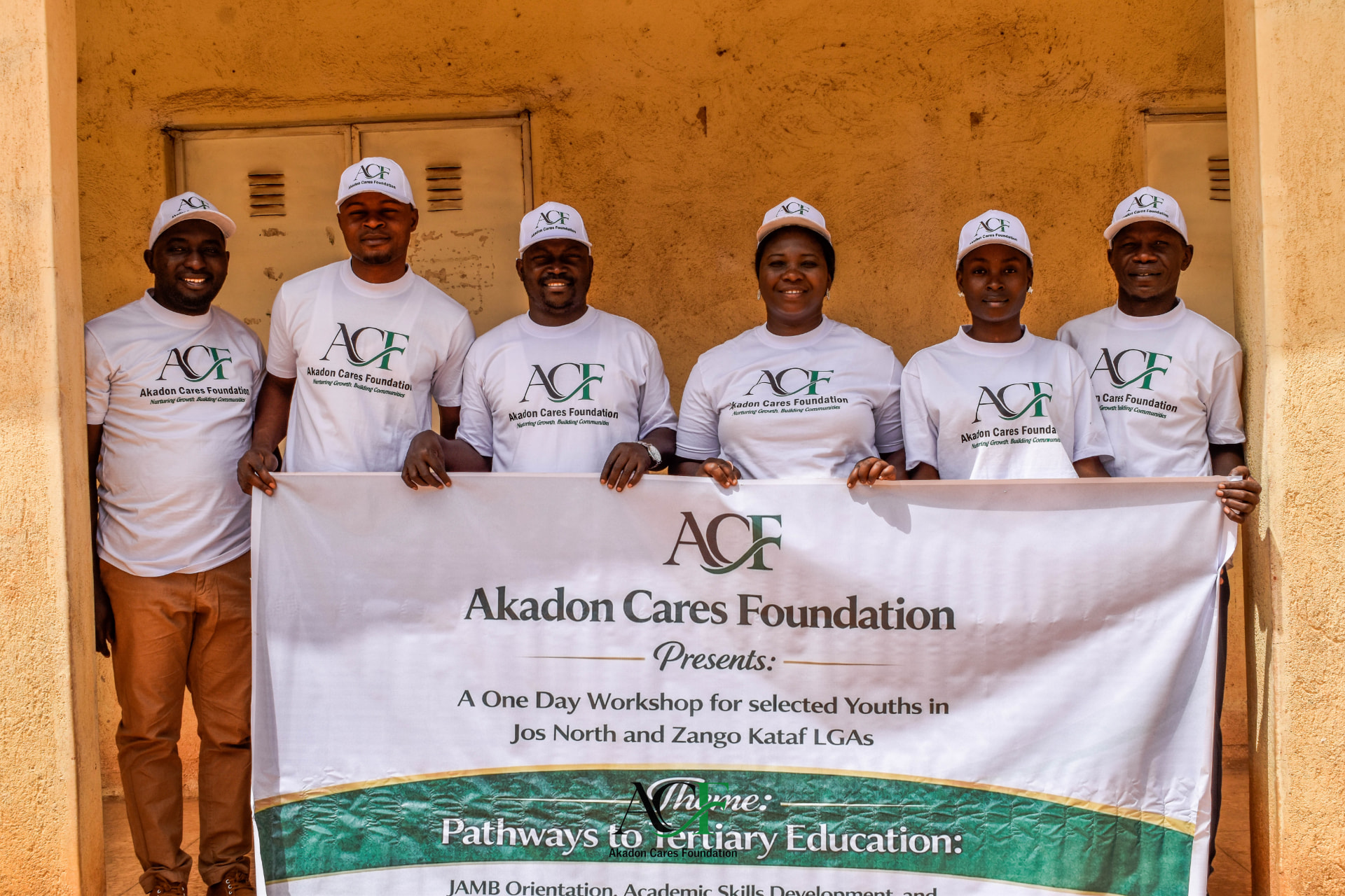 ACF team holding the workshop banner