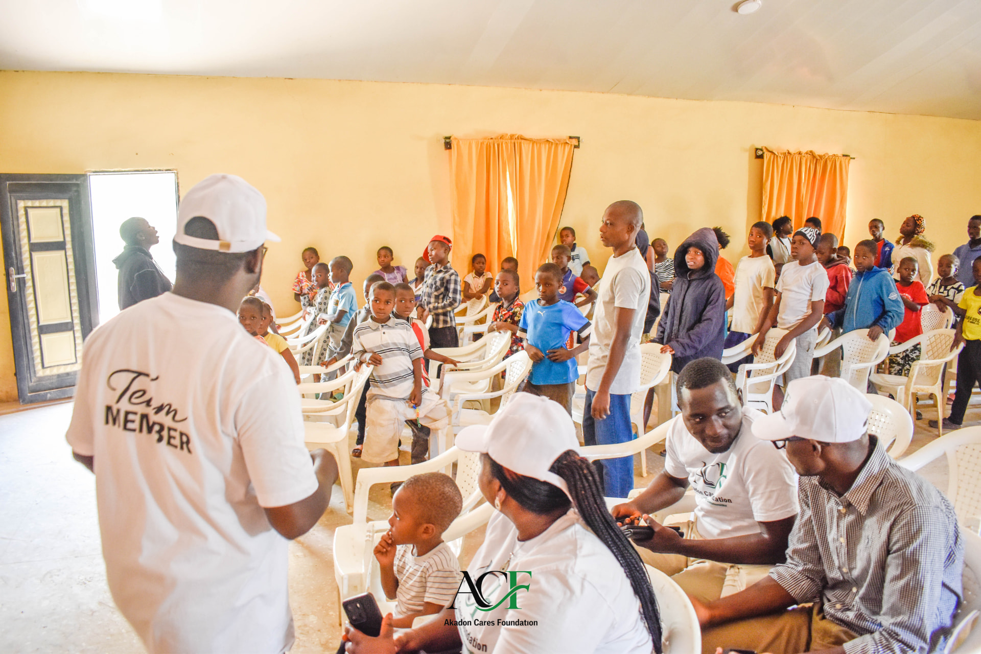 ACF team members speaking with children at the home