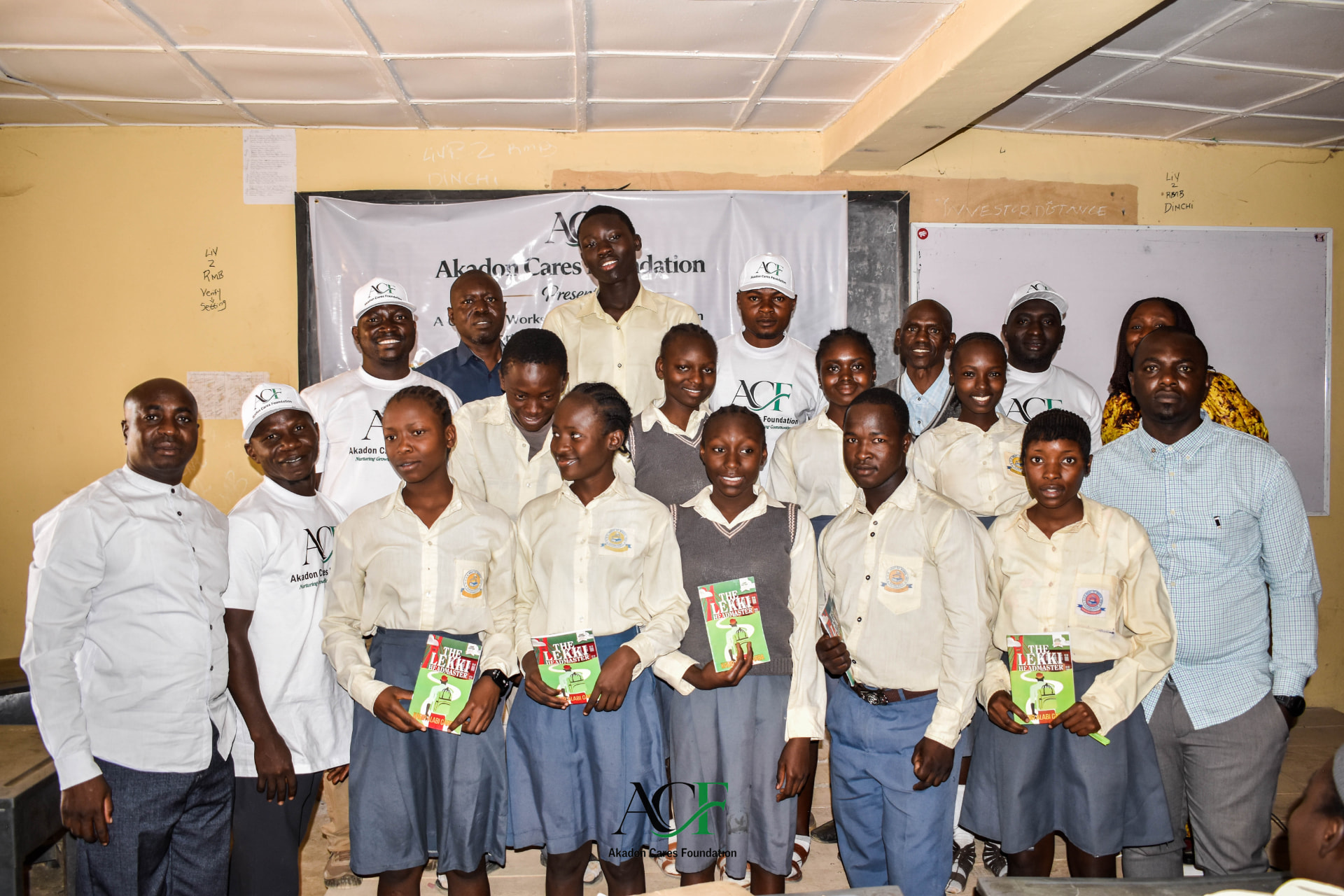 Students holding books with ACF team members