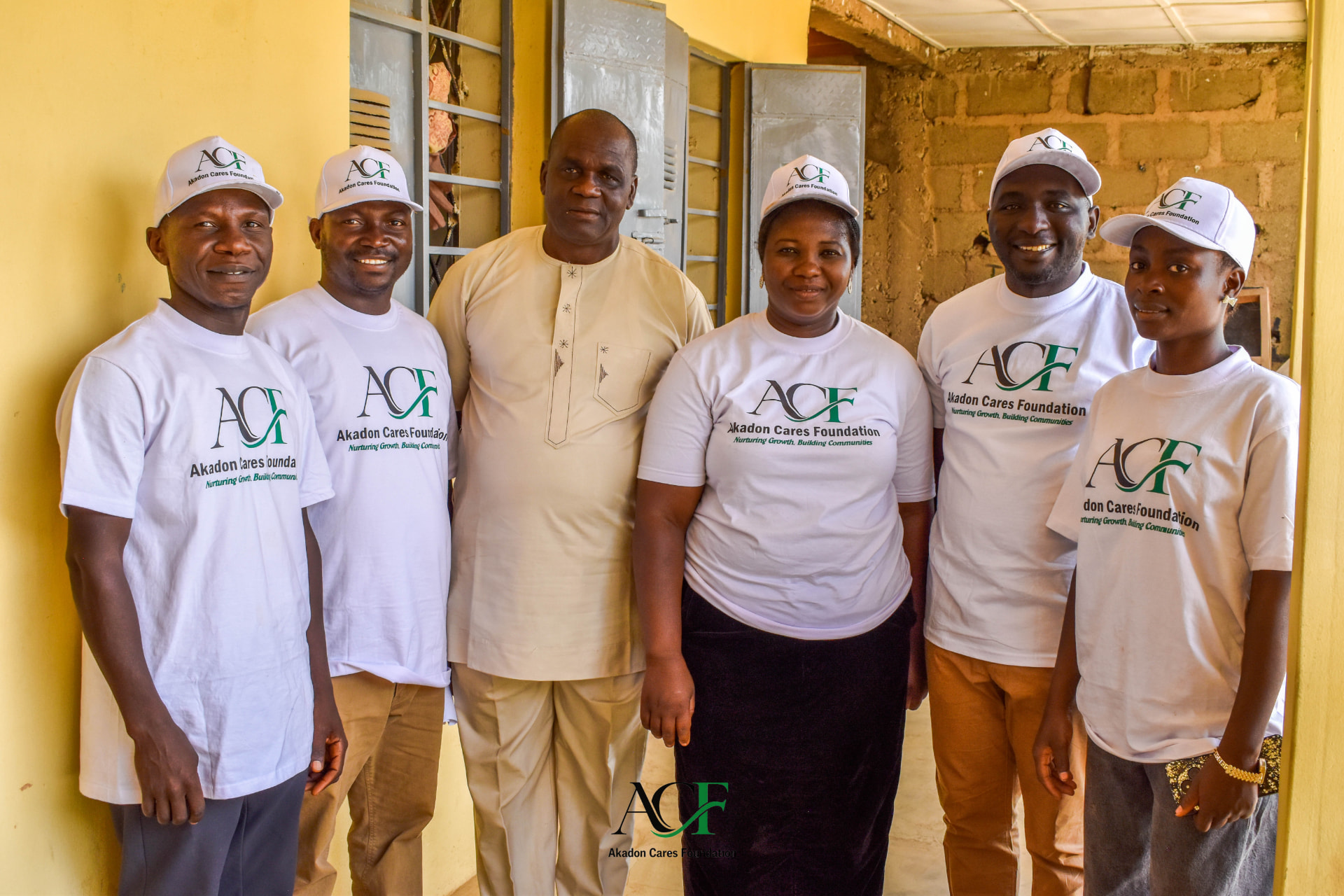 Akadon Cares Foundation team members in branded shirts and caps